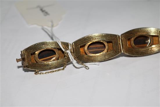 A Chinese silver gilt filligree and cabochon tigers eye quartz set bracelet, 73mm.